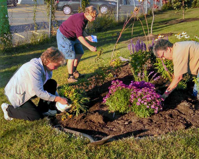 Susan McCloskey, Annie Wadleigh and Phyllis Reames helping to plant the first pollinator garden. Photo by Donna Herczeg.
