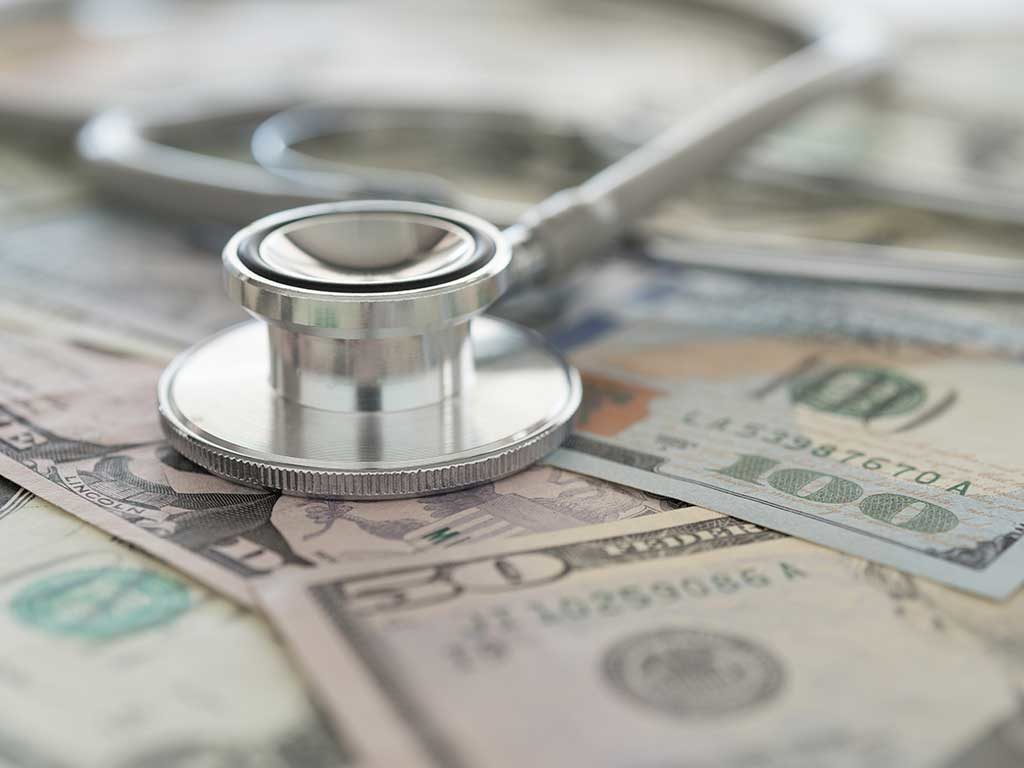 West End News - The Cost of Health Care - image of stethoscope and cash