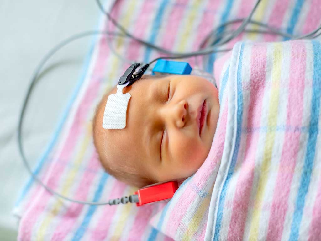 West End News - Hearing test of sleeping newborn baby