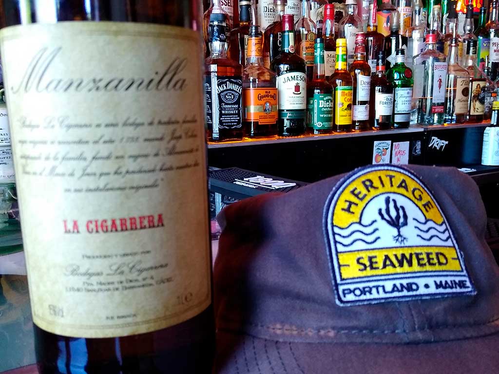 Heritage Seaweed hat next to bottle of La Cigarrera