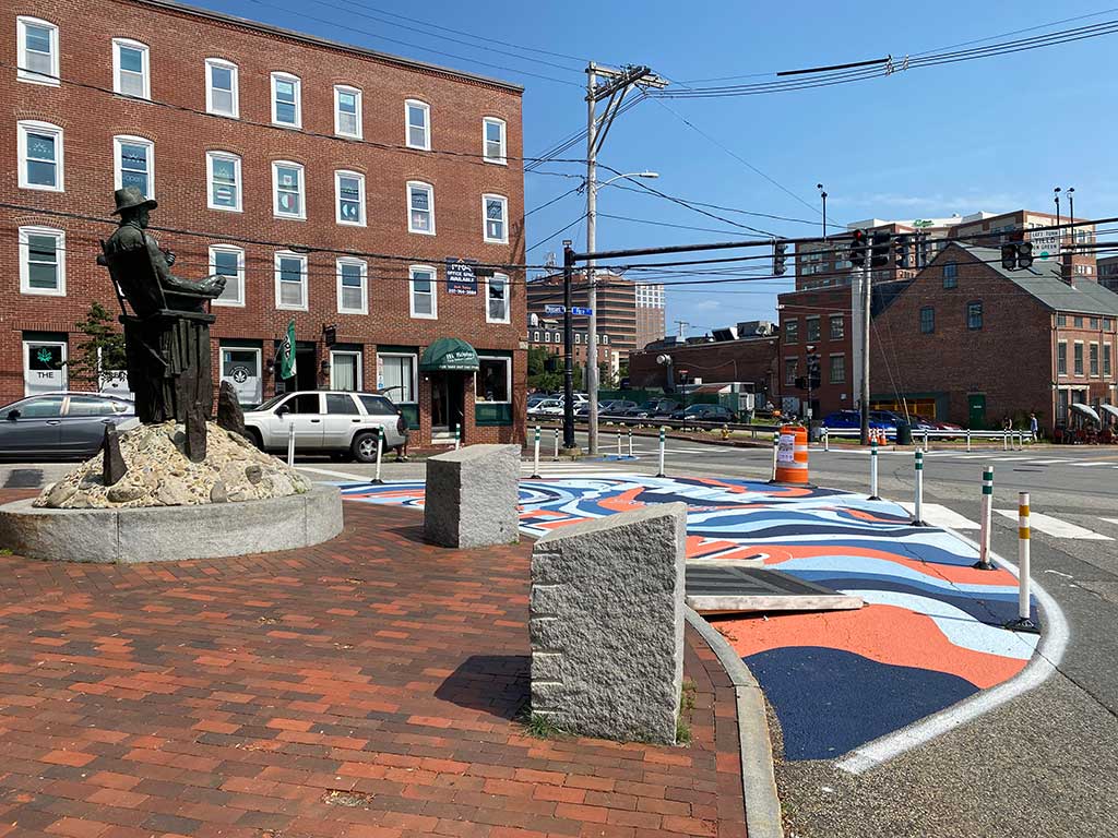 Gorham's Corner in the summer of 2023 shortly after the installation of an asphalt mural and vertical elements