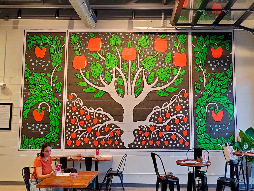 Freedom's Edge interior mural of apple tree by