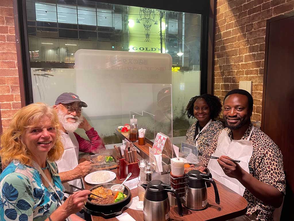 Nancy with Mandip, Dr. Gladys and husband Lawrence Zikusoka at restaurant in Sapporo