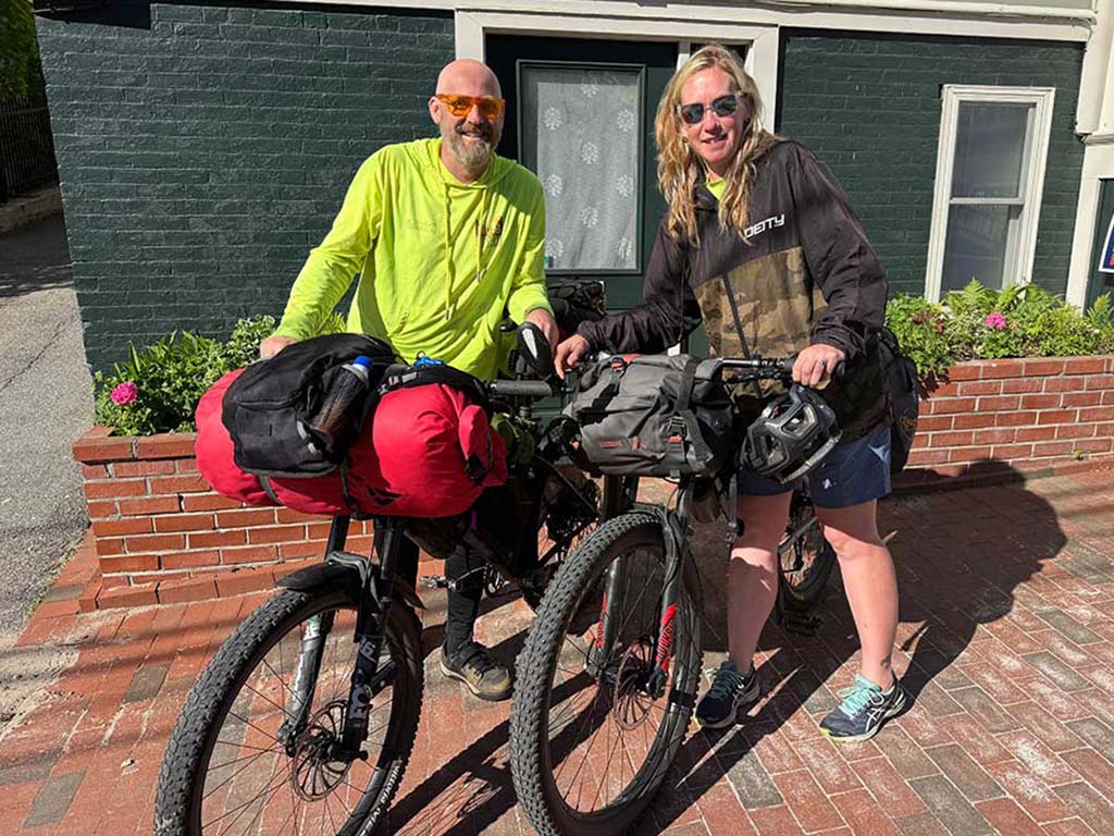 Guz and Bec with their bikes - Where's your next trip?