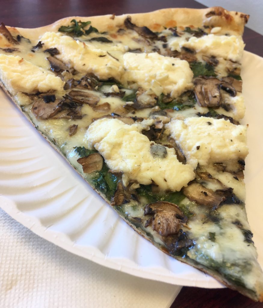 Pizzaiolo: slice of spinach, mushroom and ricotta pizza.
