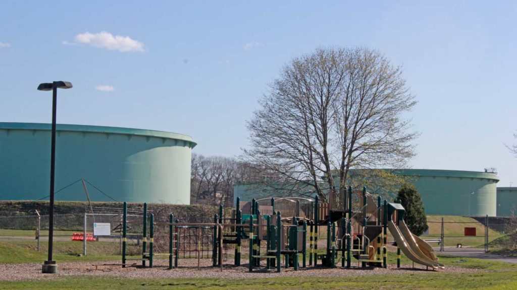 West End News - Fight for Clear Skies continues in South Portland - Here is a playground with storage tanks in background