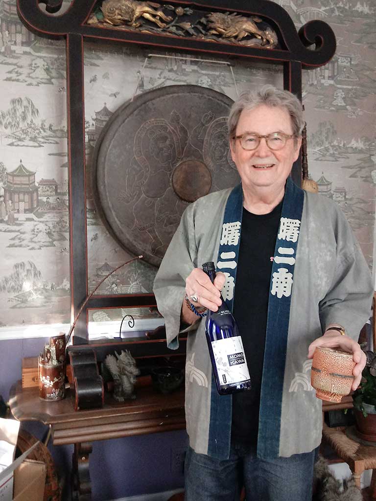 West End News - Layne V. Witherell pictured at home with gong, sake and kinomo