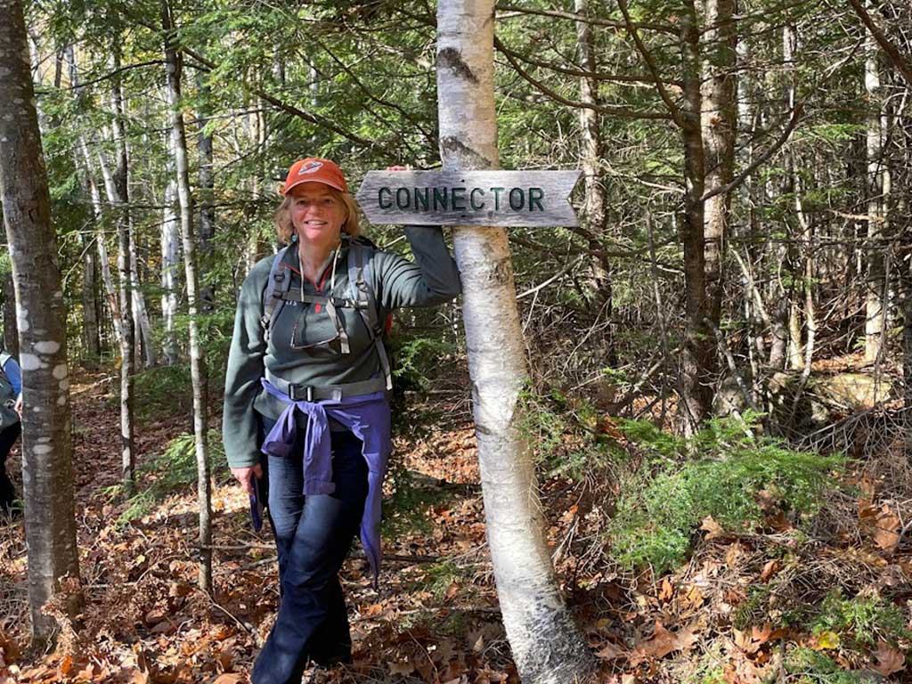 West End News - Nancy Dorrans at Connector trail sign