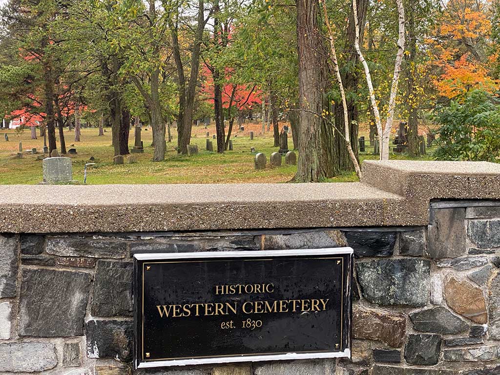 Western Cemetery entrance sign and stone wall with fall colors