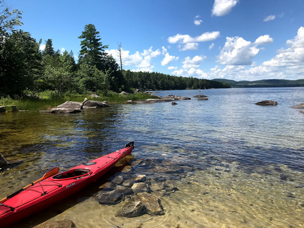 West End News - Kayak on the shores of lake in Maine - Venturing Outdoors by Nancy Dorrans