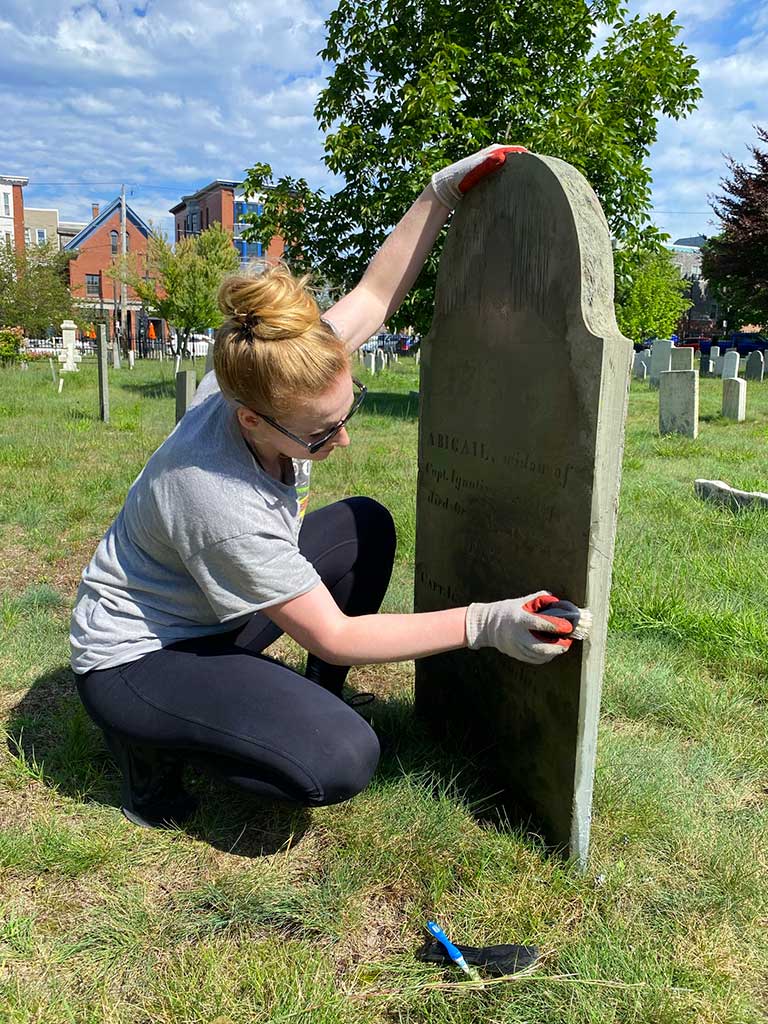 Western Cemetery - Volunteer cleaning gravestone by Peter Monro