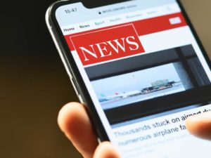 News displayed on mobile phone -By Studio_East / Adobe Stock