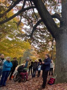 West End News - Herb Adams lectures in front of a large oak in Deering Oaks Park