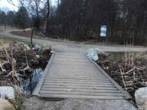 A footbridge along the trail at Capisic Pond Park downstream from the Sagamore Village rain garden project