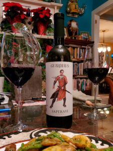 West End News - Layne's Wine Gig - Guardians Saperavi bottle and distinctive label with plate and poured glasses