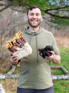 Louis Giller holds mushrooms