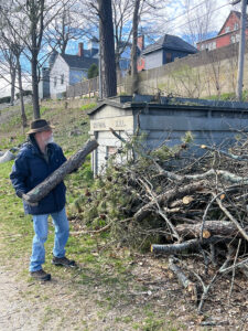 Volunteer clearing tree debris from March and April storms at Western Cemetery - April 2024