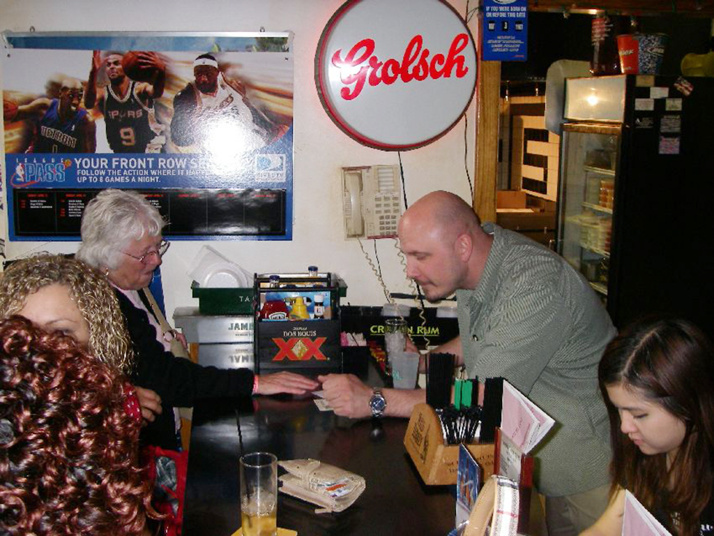 Joanie giving her business card to a bartender in Chicago