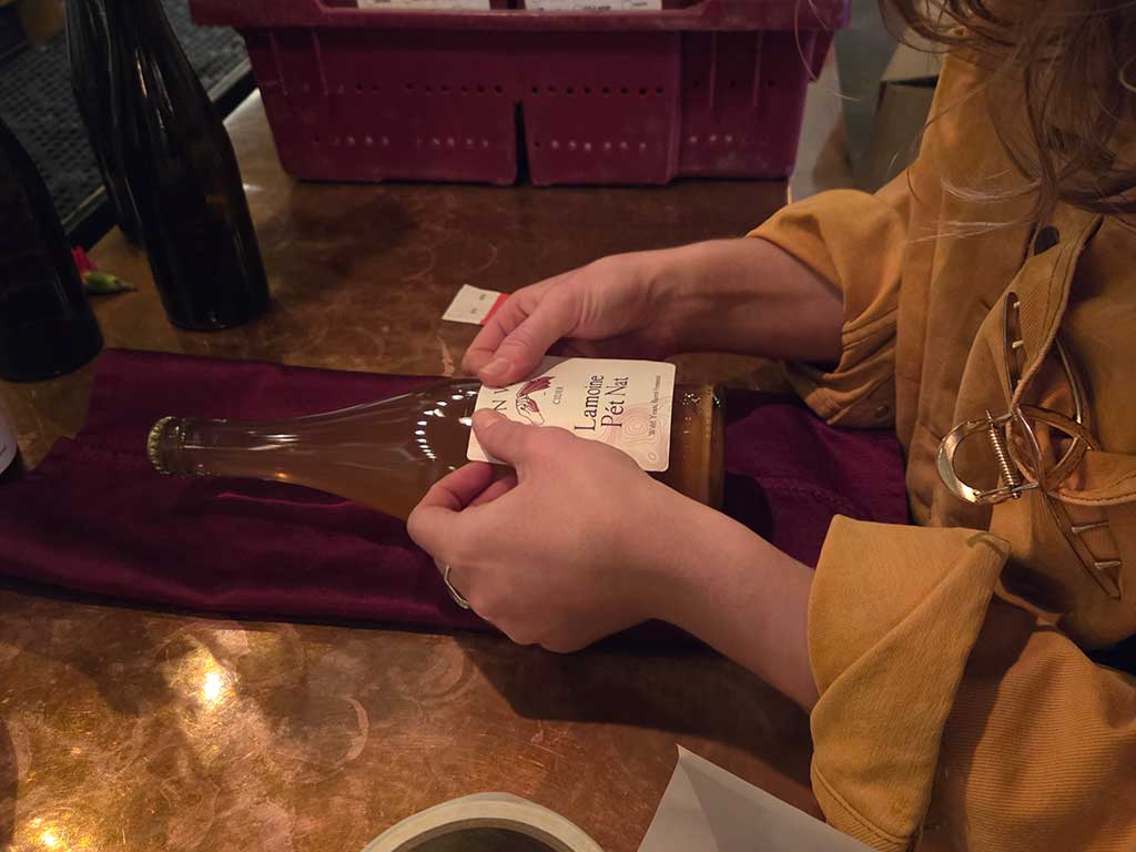 Hand labeling cider bottles